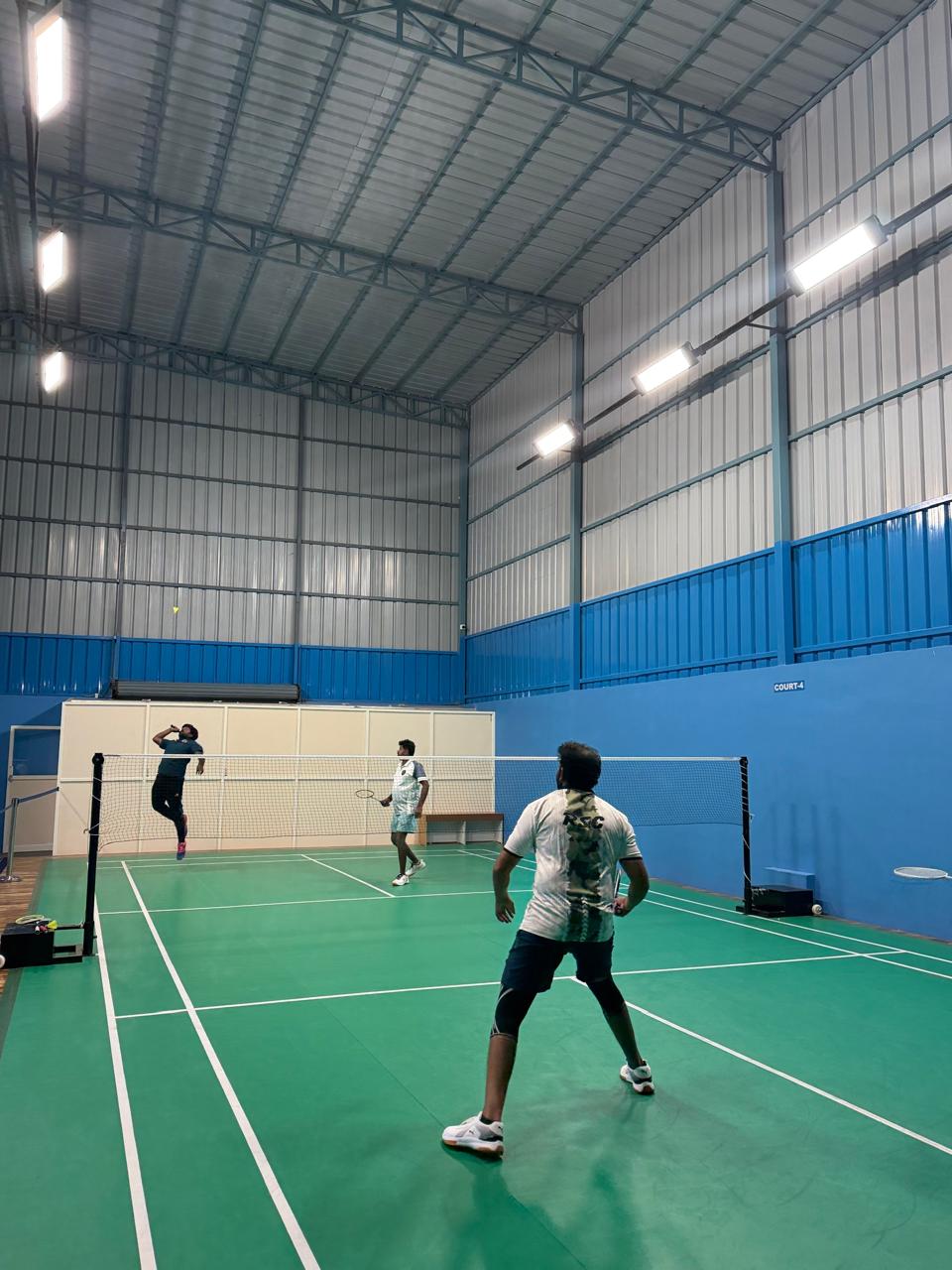 Players on indoor badminton court